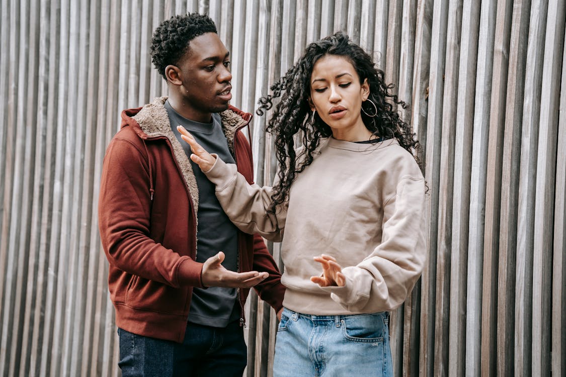 https://www.pexels.com/photo/frustrated-multiethnic-couple-having-argue-on-street-6147233/