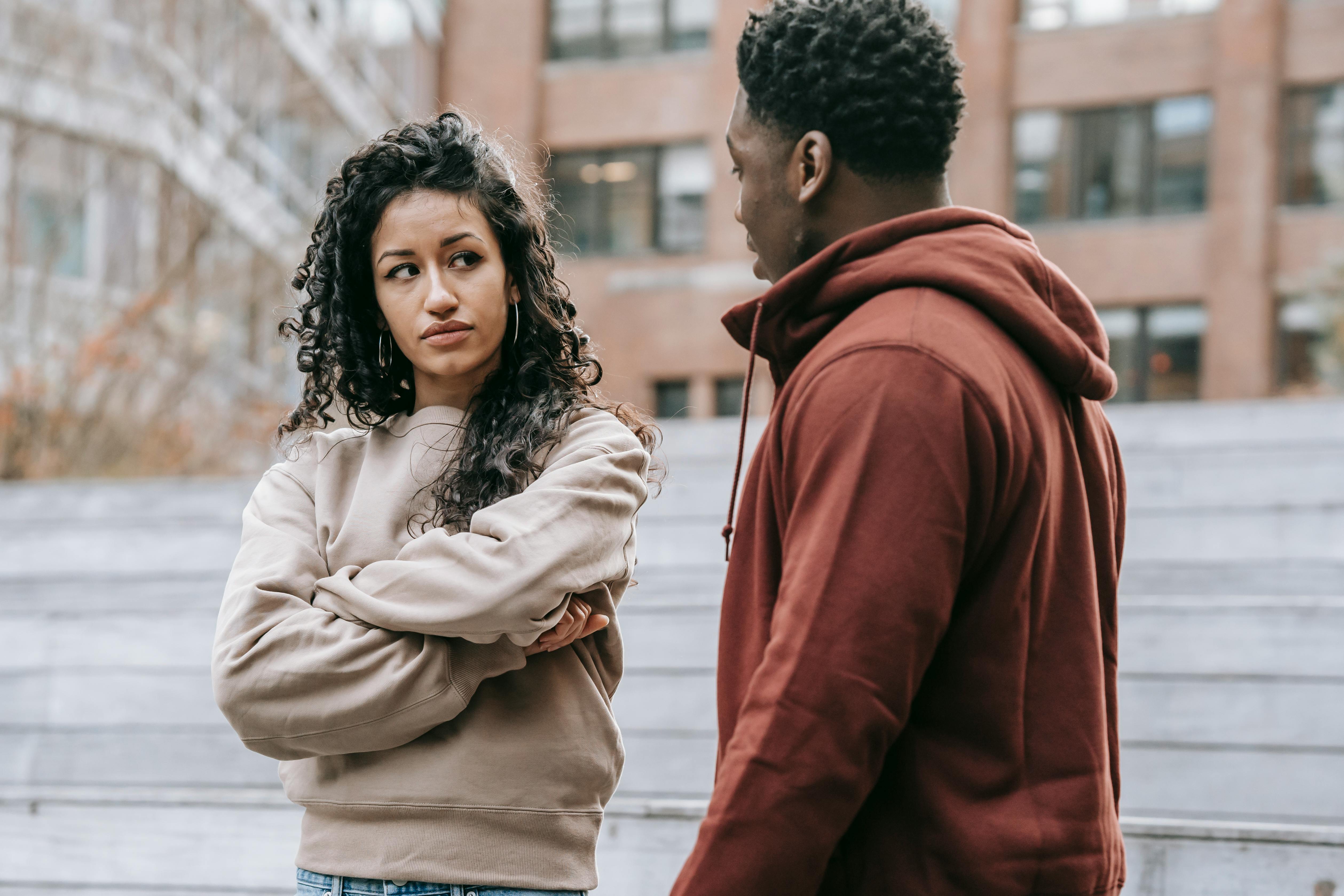 disappointed multiethnic couple having argument on street