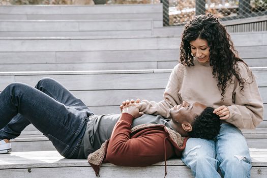 Multiethnic couple holding hands on steps