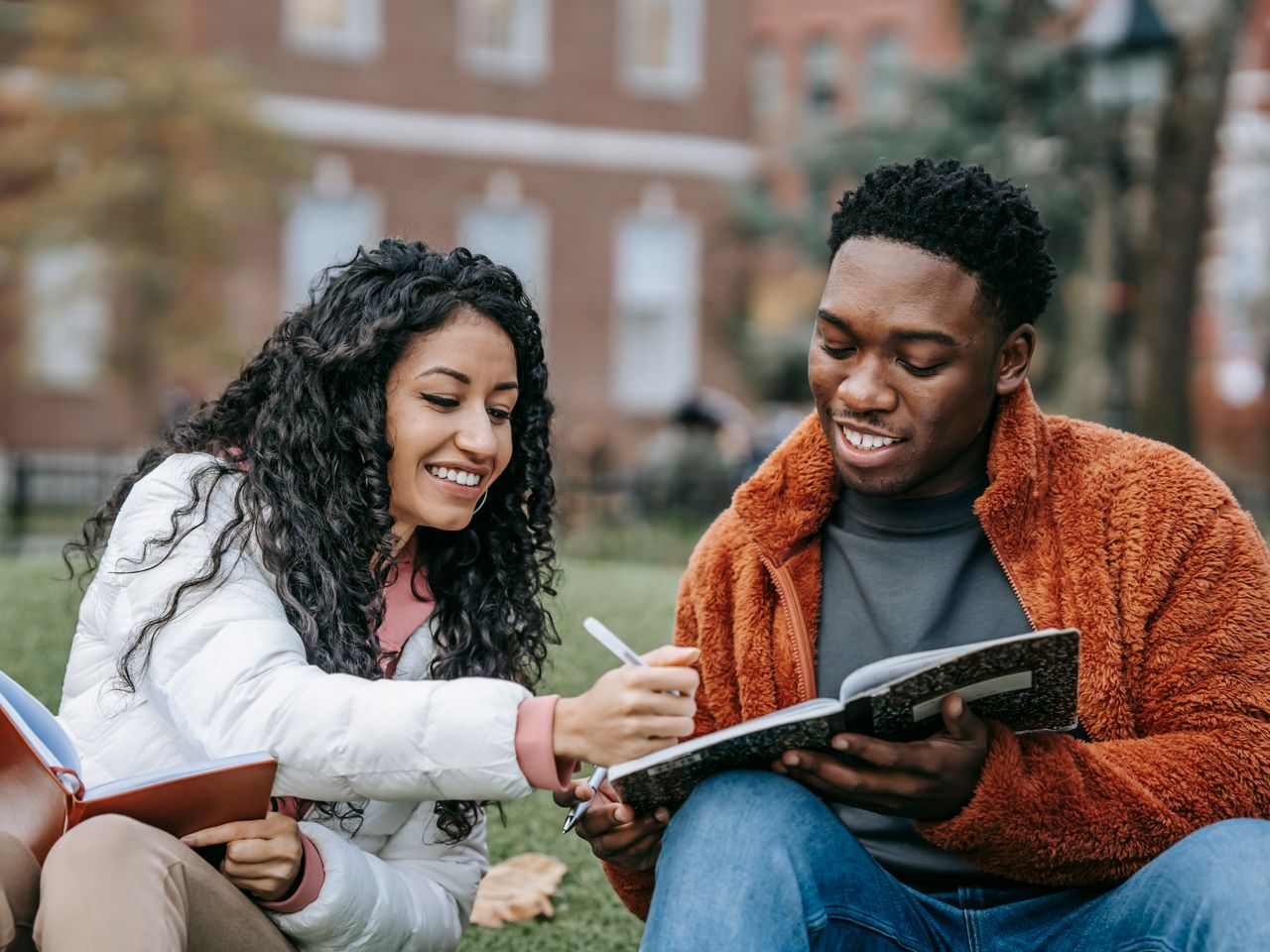 A Black male student and a White female student working together on a project