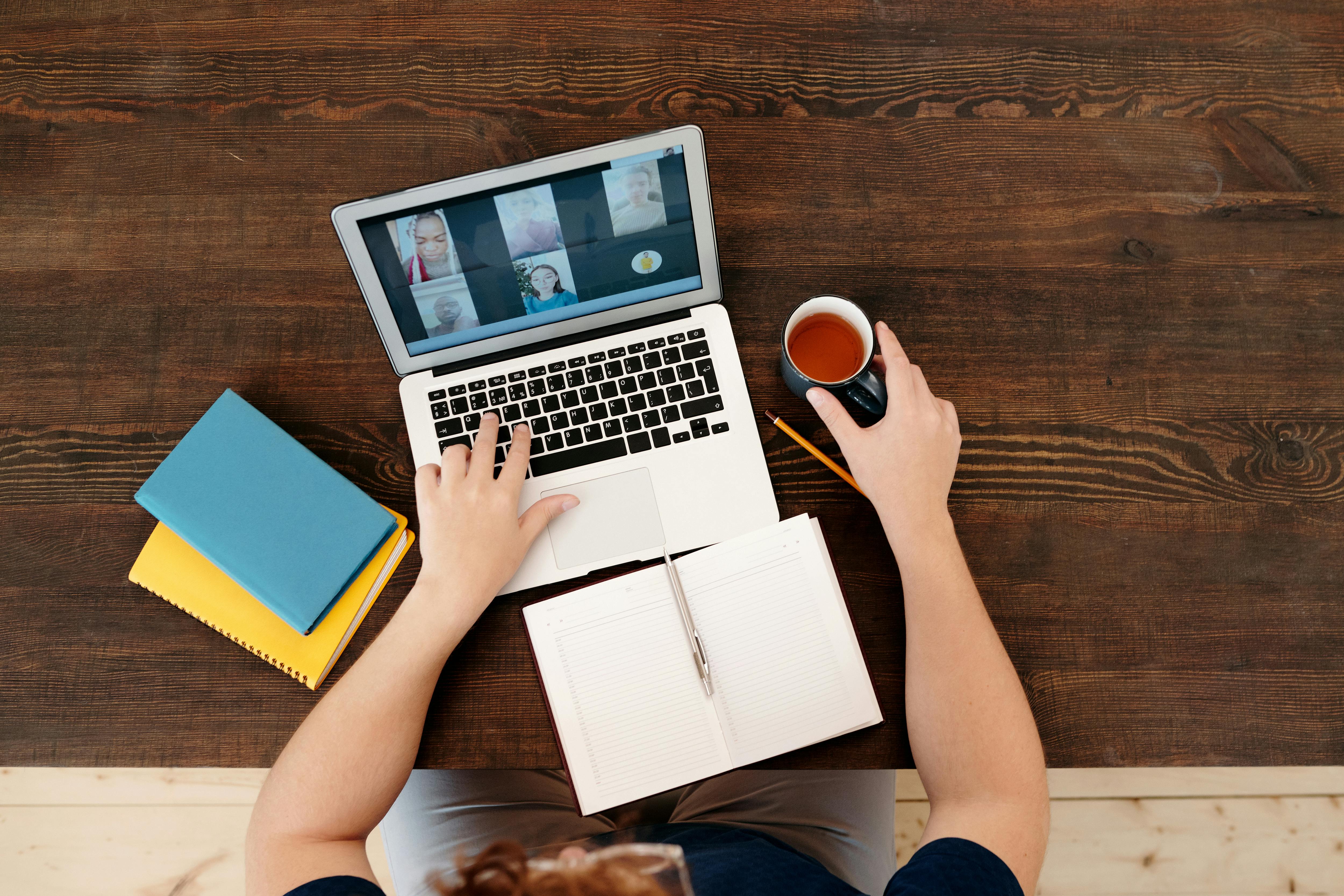 Person attending a virtual meeting on laptop