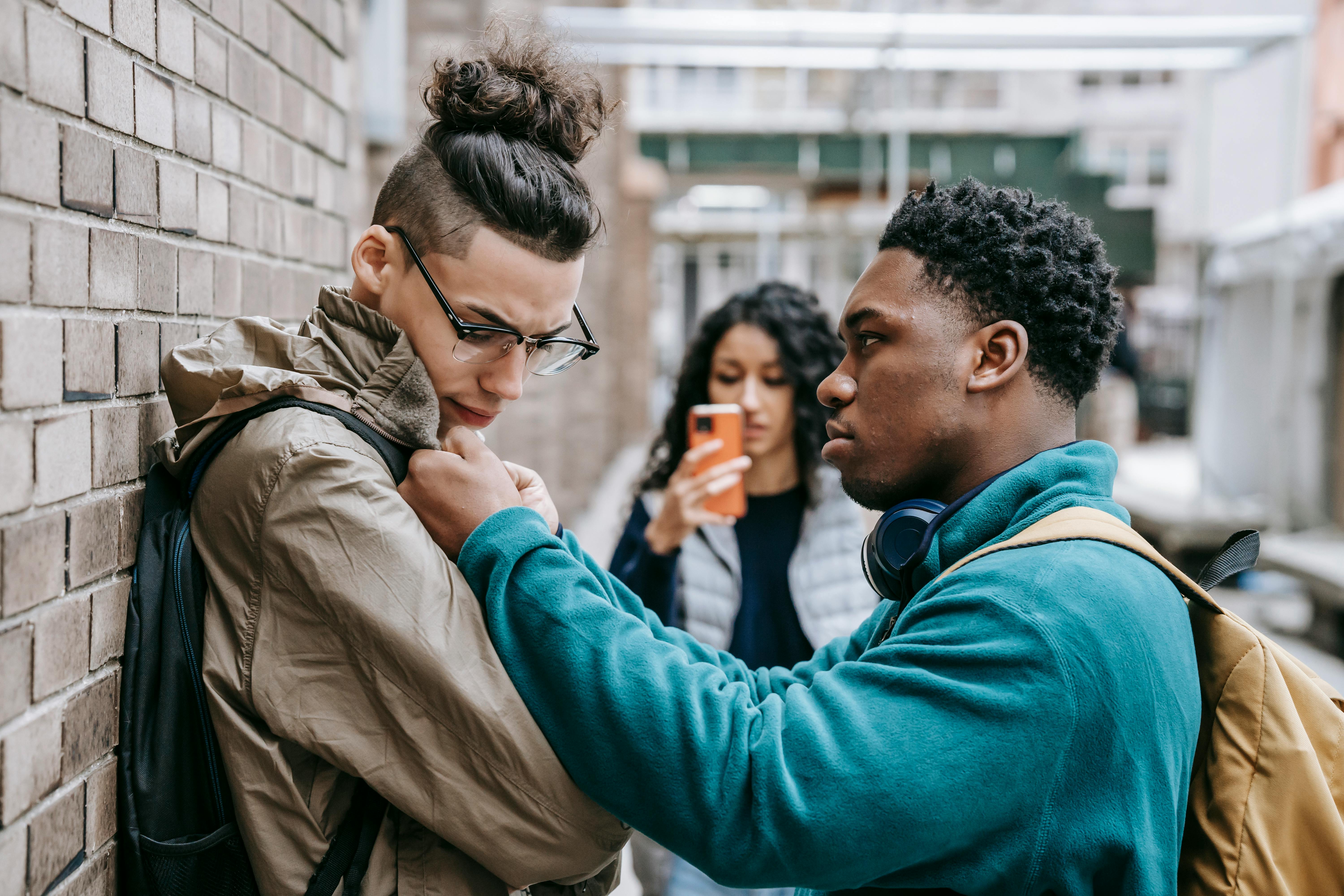 multiracial students having argument on city street