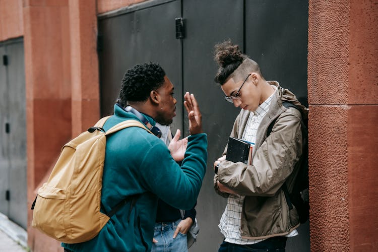 Annoyed Black Man Arguing With Friend On City Street