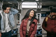 Crop smiling multiracial friends talking in underground