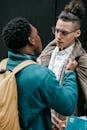 Anonymous angry black man arguing with friend outdoors
