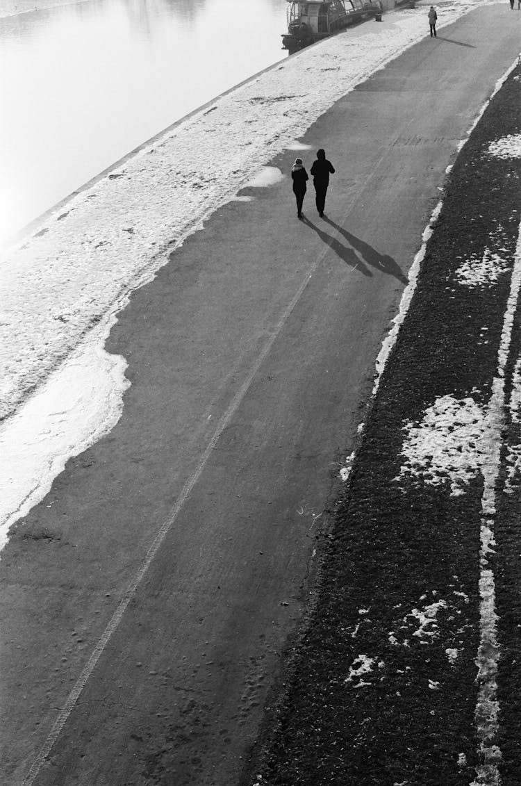 High Angle Shot Of A Couple Walking On A Road