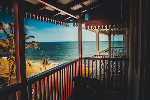 Free stock photo of balconies, blue skies, coconut trees