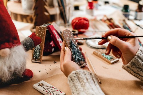 Free A cozy close-up of holiday crafting with paint and decorations for Christmas. Stock Photo