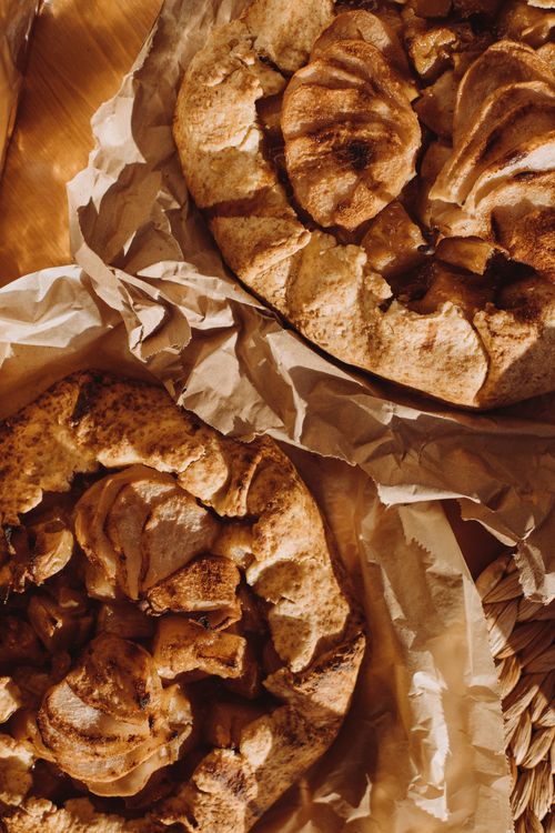Free Mouthwatering baked apple galettes with cinnamon, perfect for a cozy treat. Stock Photo