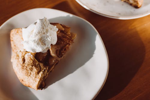 Sliced of Cake with Whipped Cream on Top