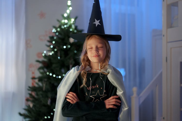 A Girl Wearing A Wizard Hat And Cloak