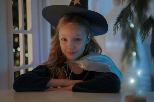 A Girl Smiling while Sitting at the Table