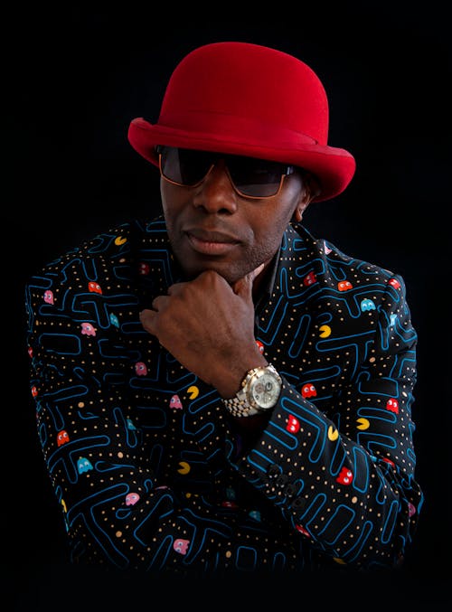 A Man in Suit Jacket and Red Hat