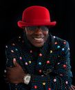 Man in Blue and Yellow Button Up Shirt Wearing Red Hat