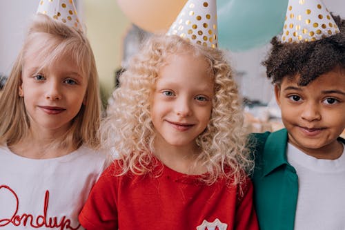 Three Children Wearing Party Hat