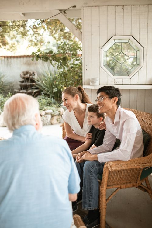 Free Diverse family bonding in a bright living room, sharing smiles and conversation. Stock Photo