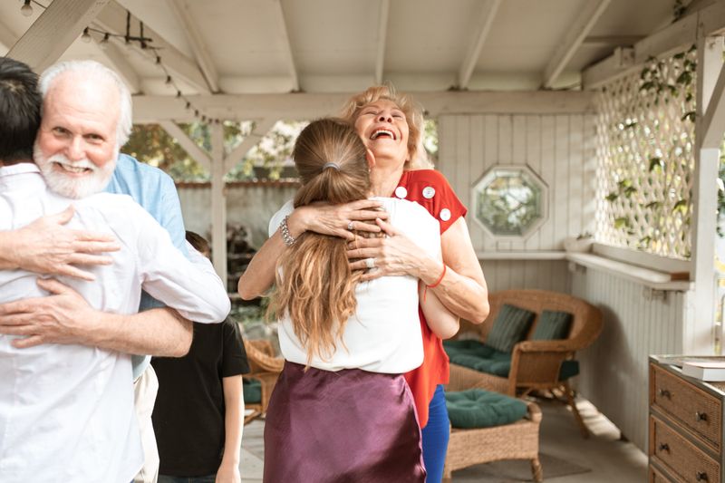 A heartwarming reunion with family members hugging and smiling in a cozy indoor setting