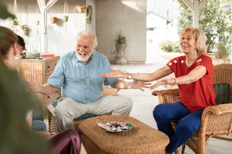 Surprised Grandparents Talking To Family On Patio