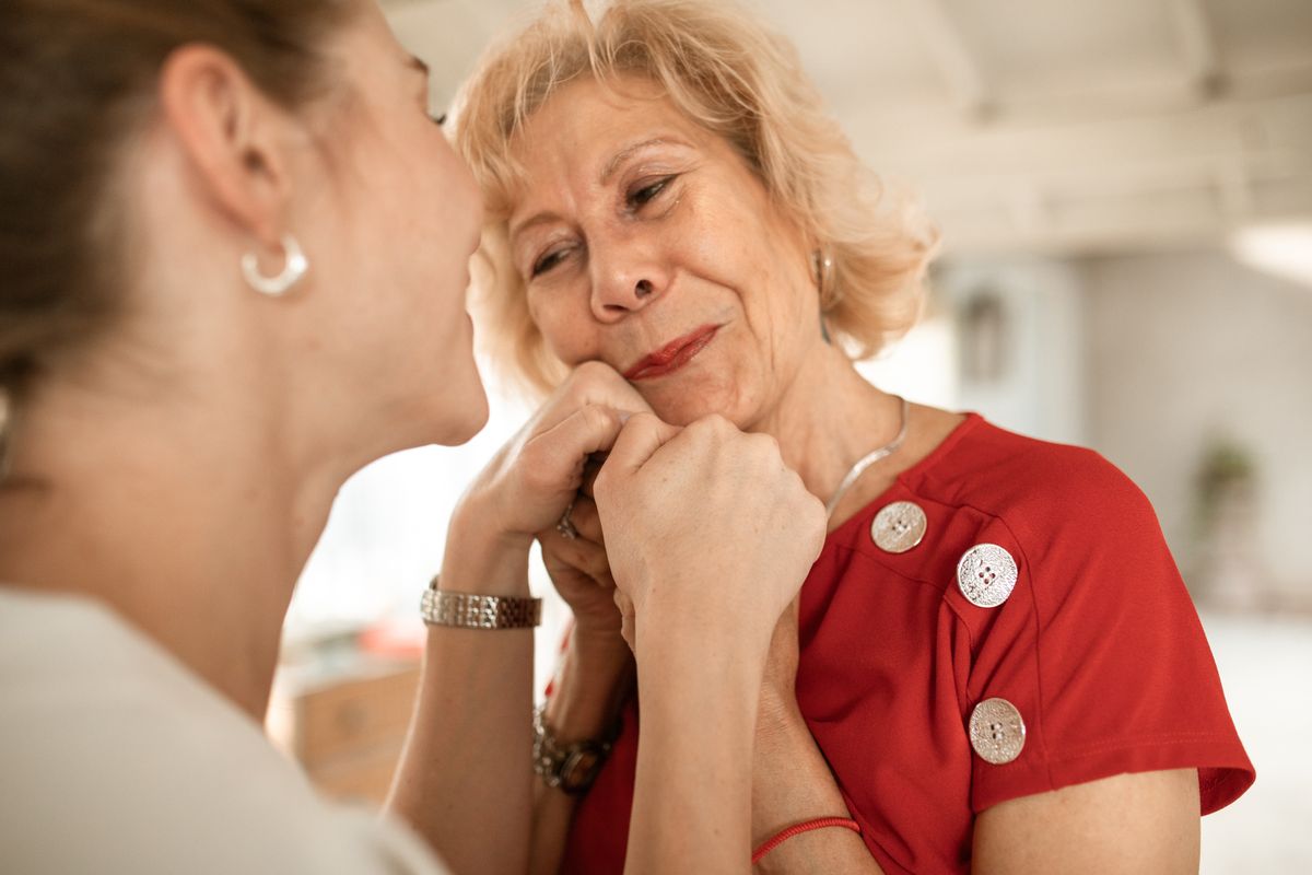 Your Elderly Parent's Breath Changed: What It Means and How to Help 1 Adult daughter sitting close with her elderly mother indoors, noticing bad breath in older adults