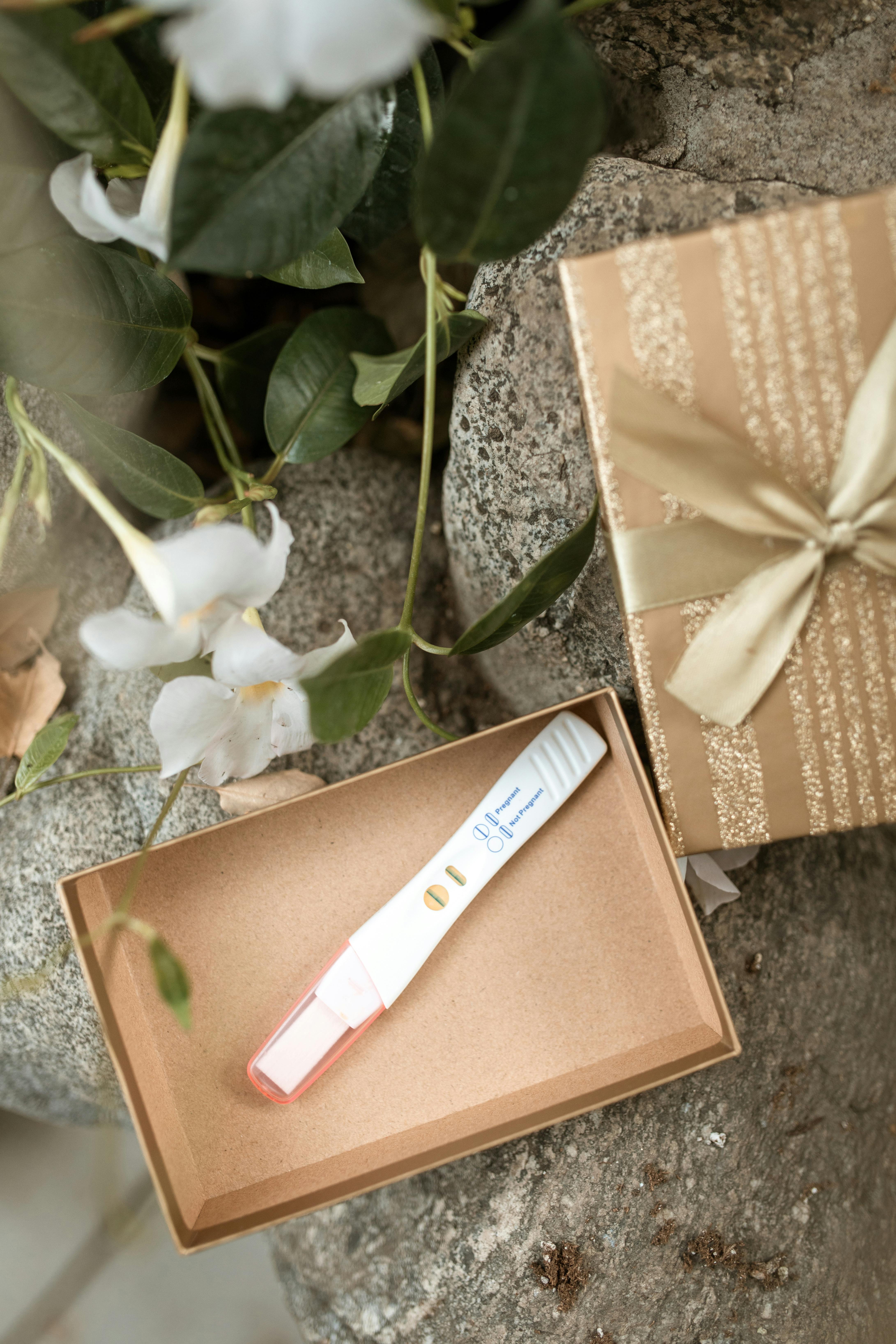 brown and white gift box with white ribbon