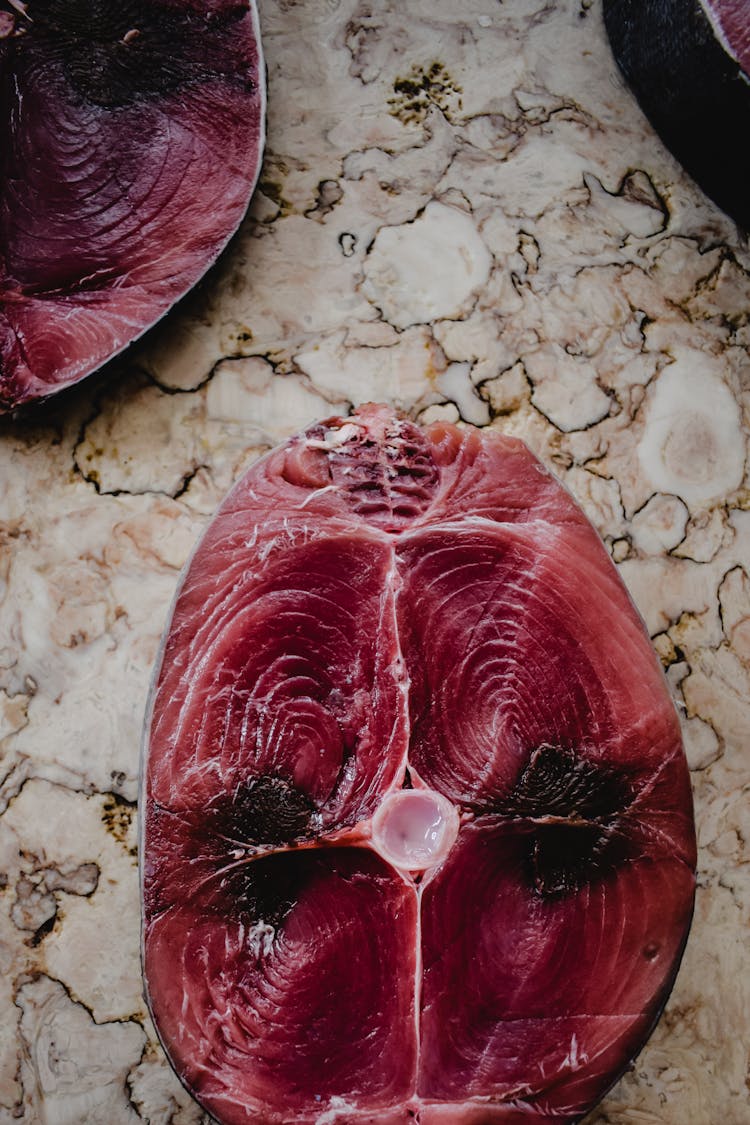 Uncooked Sliced Fish On Marble Surface 