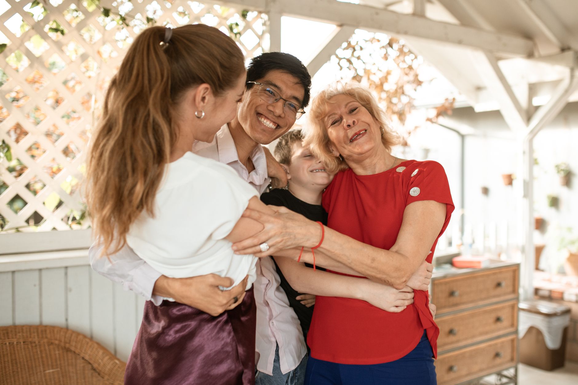 A joyful family group hug with diverse members expressing love and happiness.