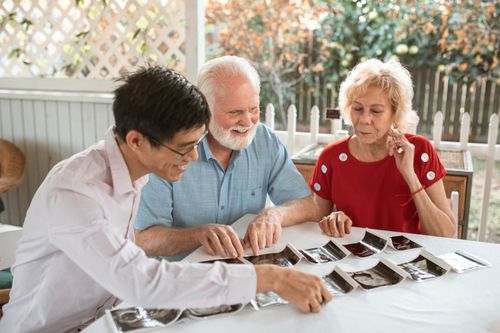 Free A group enjoying an outdoor moment while going through ultrasound images. Stock Photo