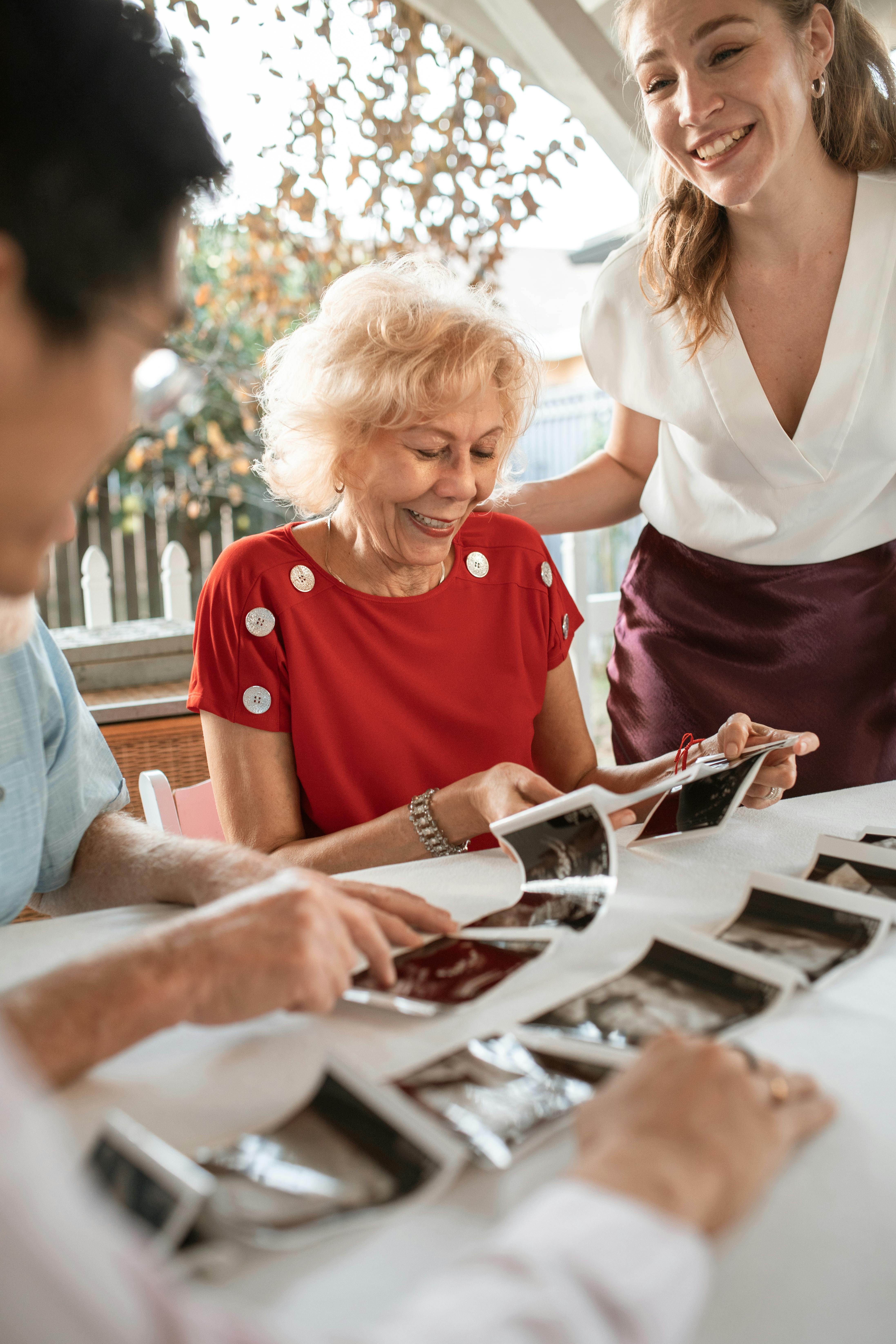 couple showing ultrasound photos to their parents