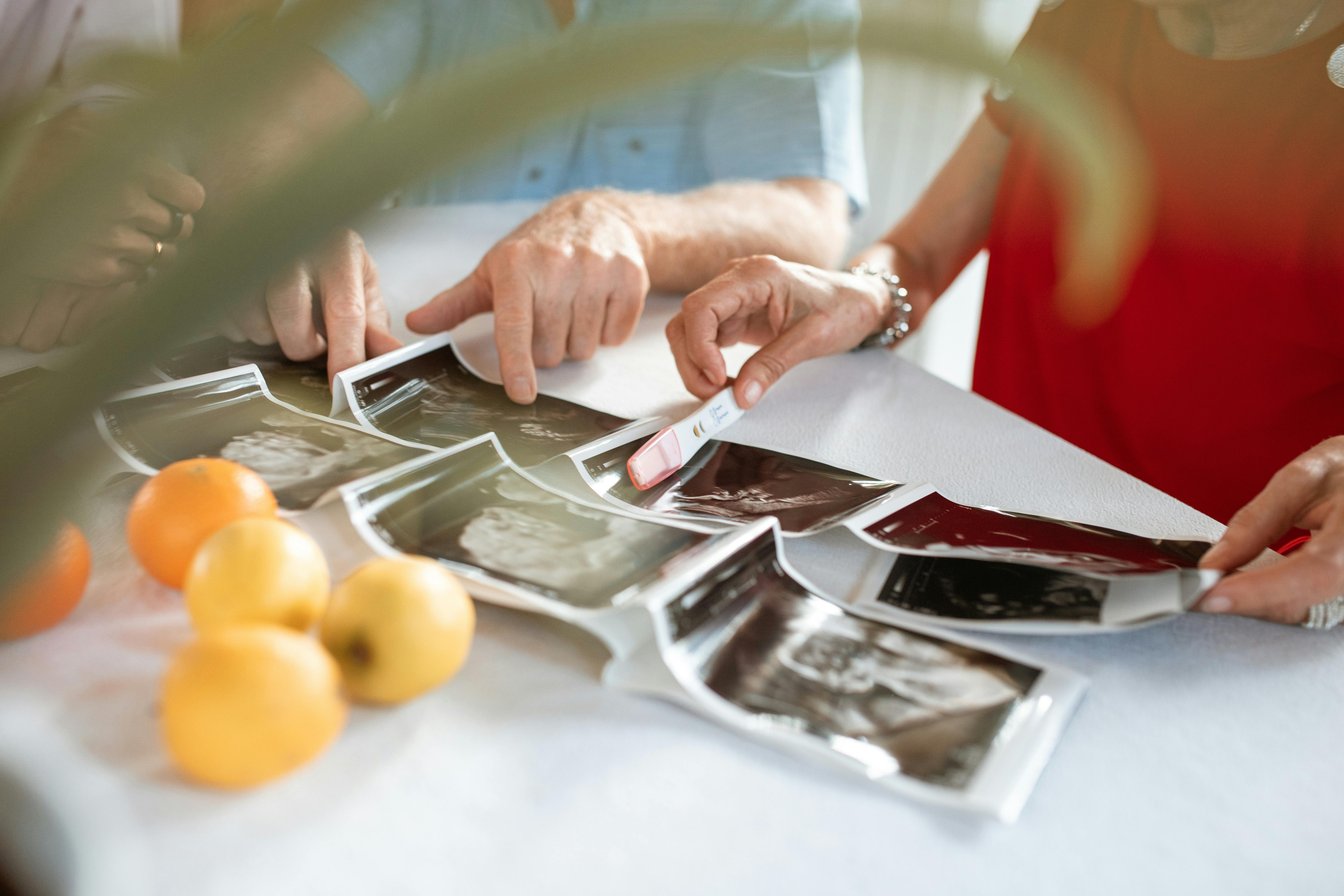 person holding silver and orange round fruits