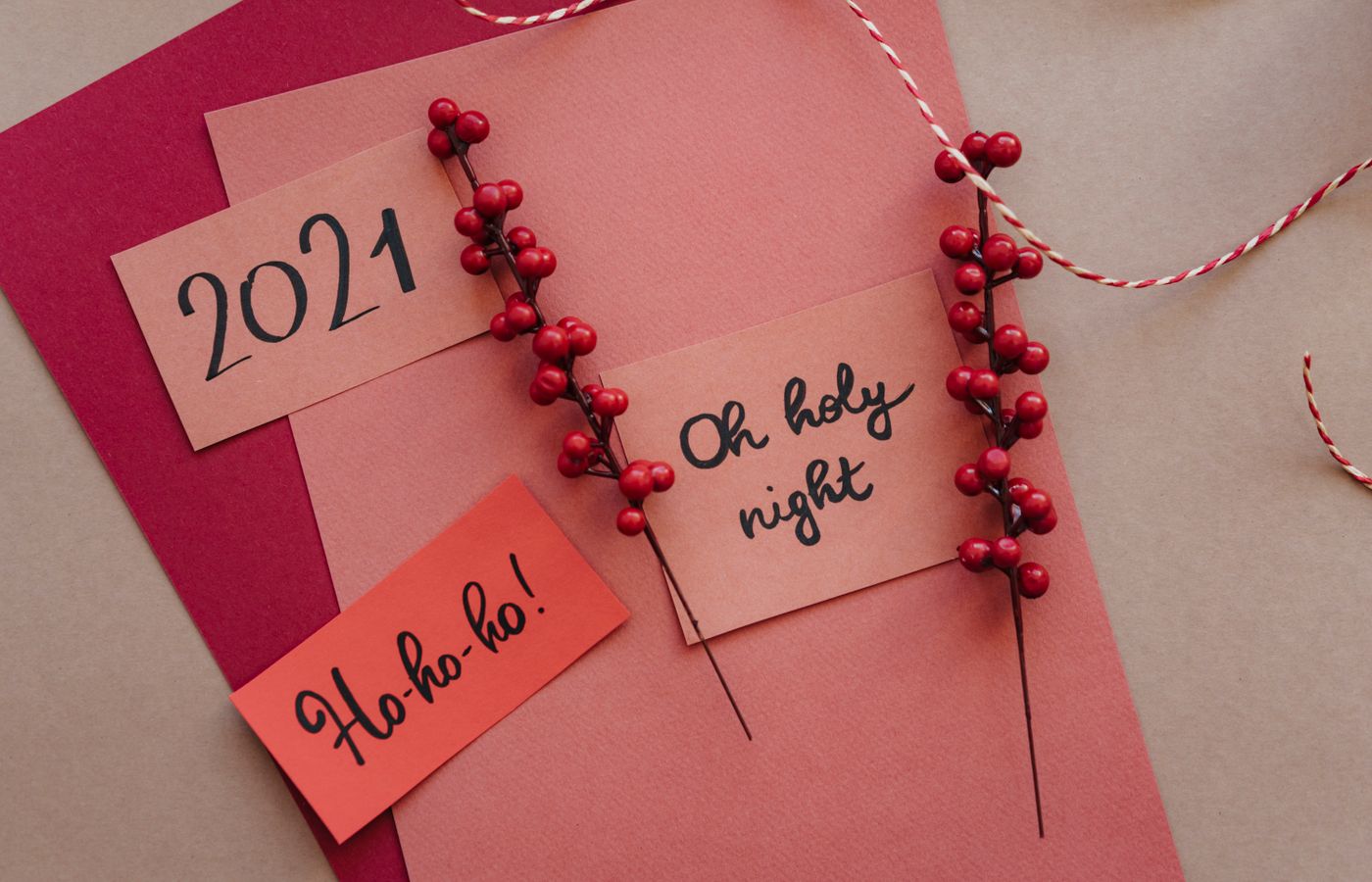 Stylish Christmas card layout featuring red and gold hues with festive greetings and decorations.