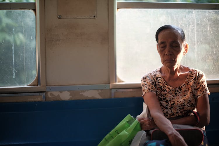 Elderly Woman Sitting In Old Bus