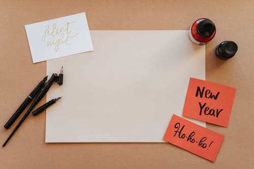 Greeting Cards, Ink Bottles and Fountain Pen on the Table