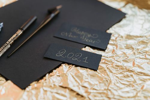 Free Close-up of a stylish New Year 2021 card setup with black paper and pens. Stock Photo