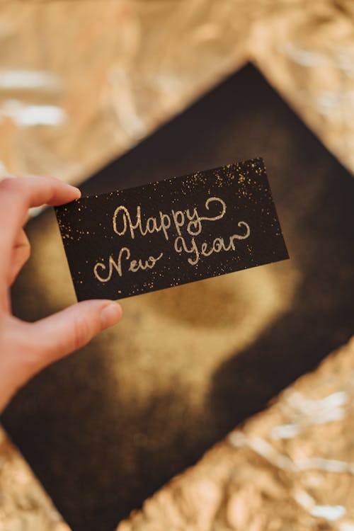 Hand Holding a Black Card with Message 