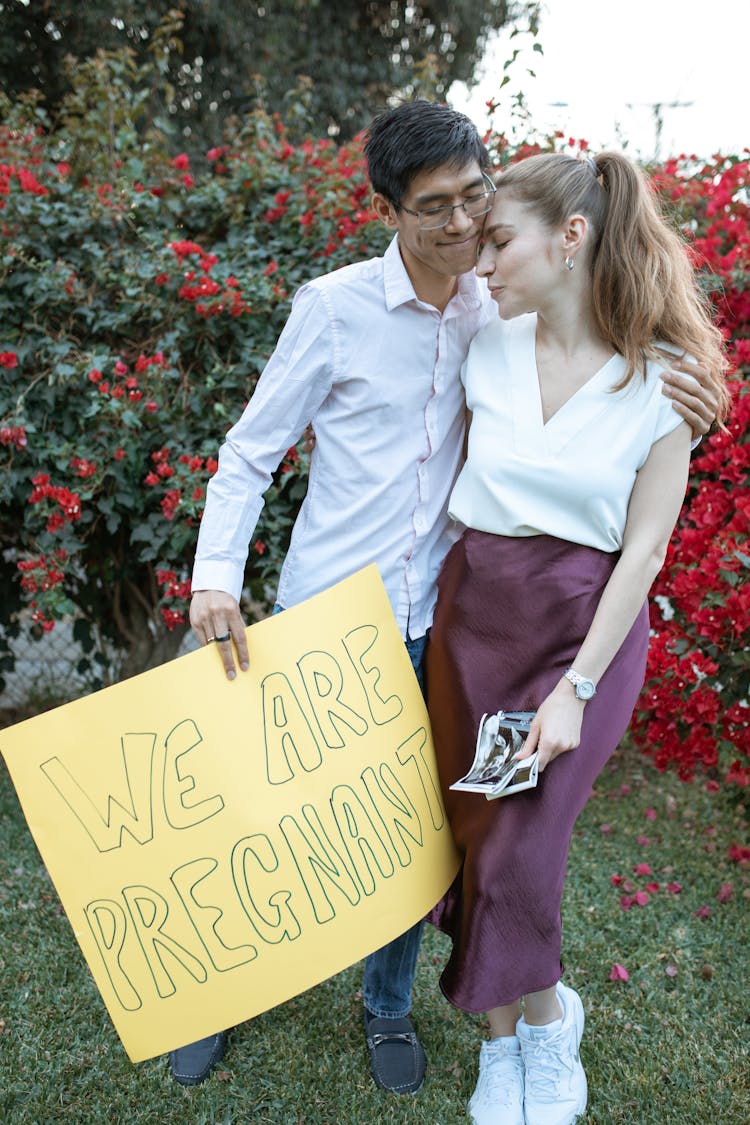 Man In White Long Sleeves Holding A Banner With Message 