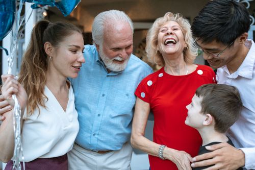 Free A joyful family gathering with diverse generations sharing a light moment outdoors. Stock Photo