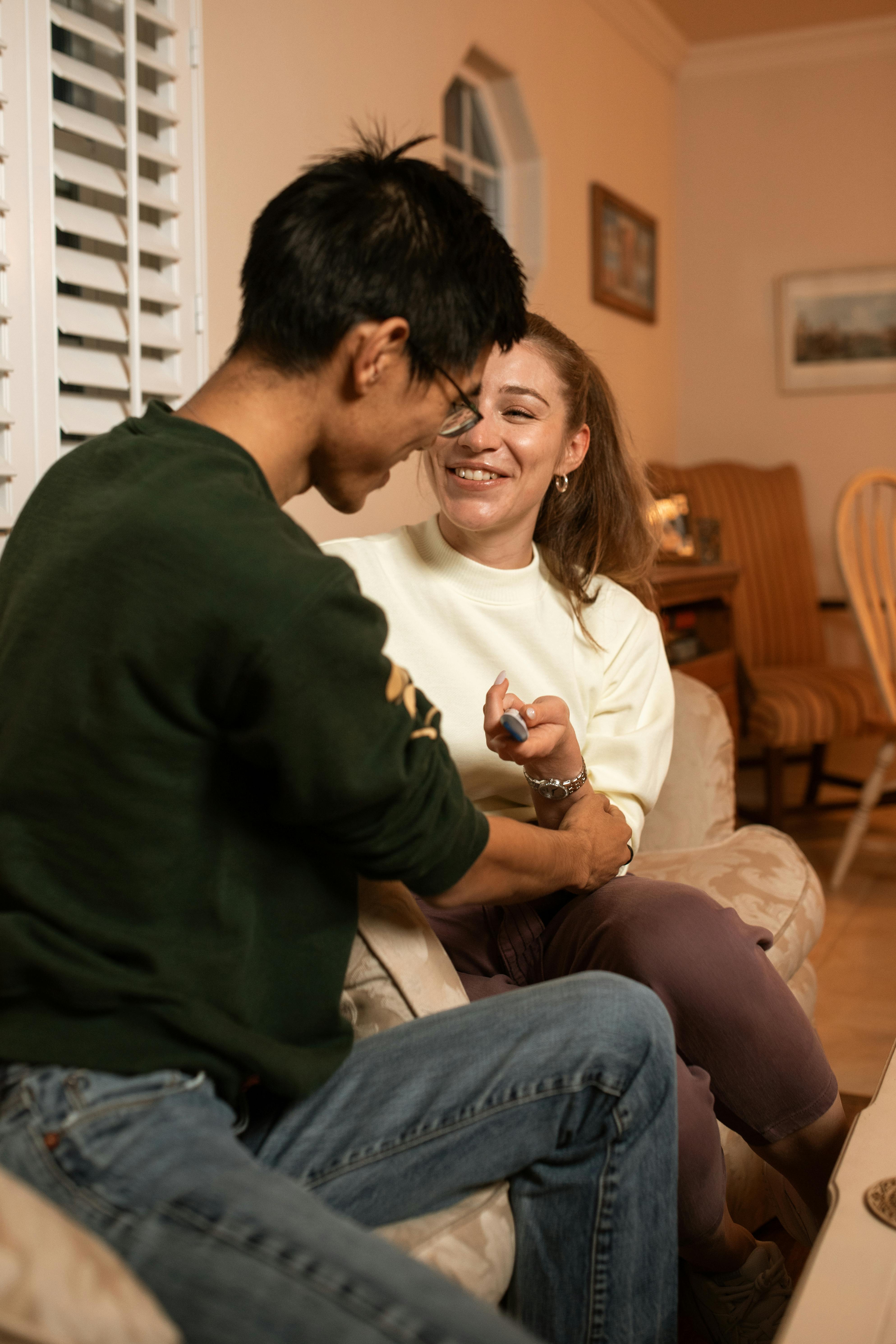 man in black sweater sitting beside woman in white sweater