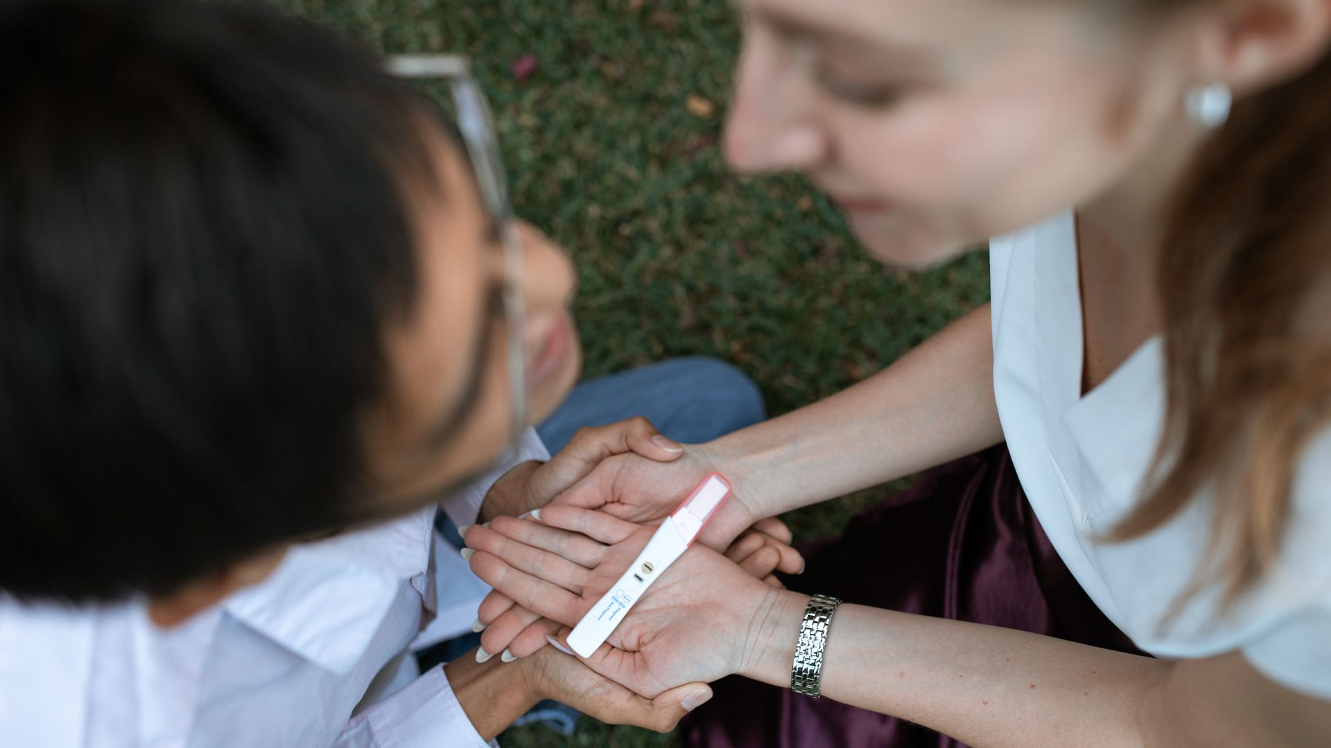 Modafinil Effect on Fertility: What You Need to Know A happy couple joyfully reacts to a positive pregnancy test result in a serene outdoor setting — modafinil effect on fertility