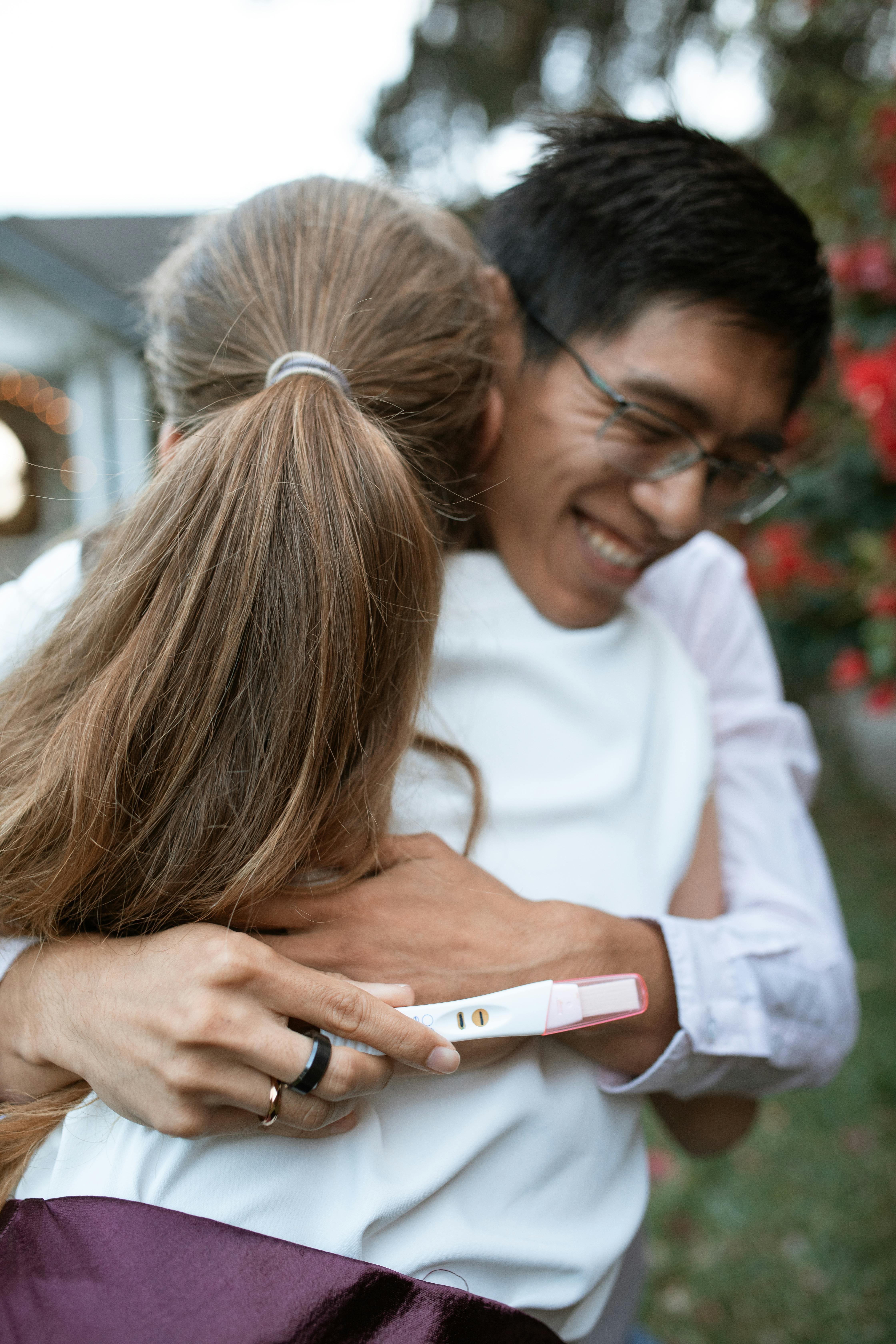 woman in white crew neck shirt holding silver iphone