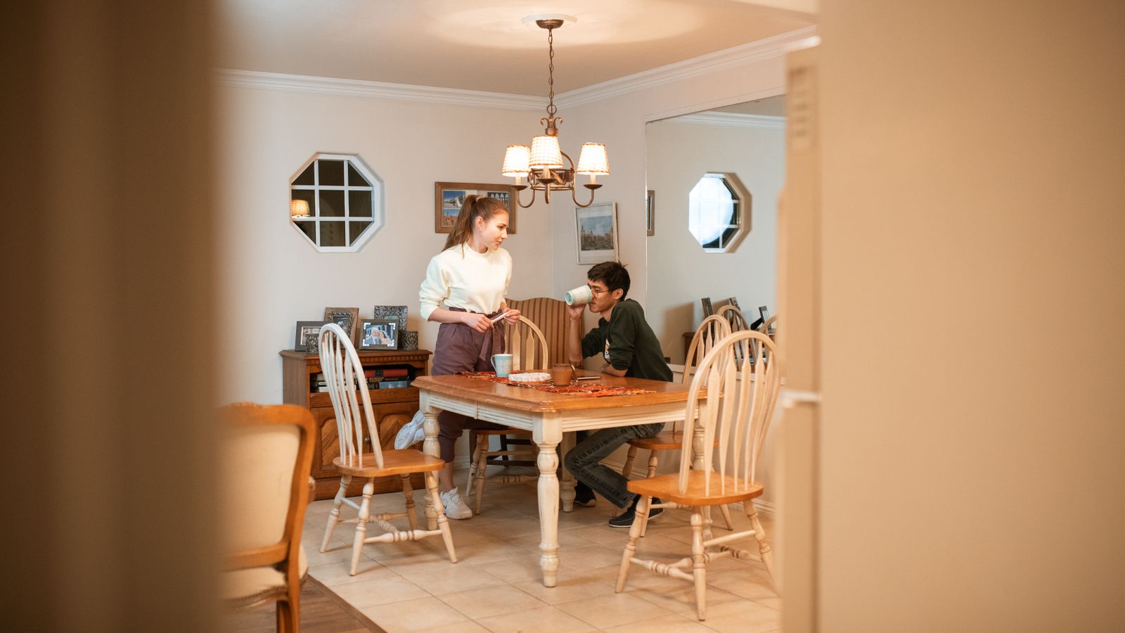 Two adults having a conversation at a dining table
