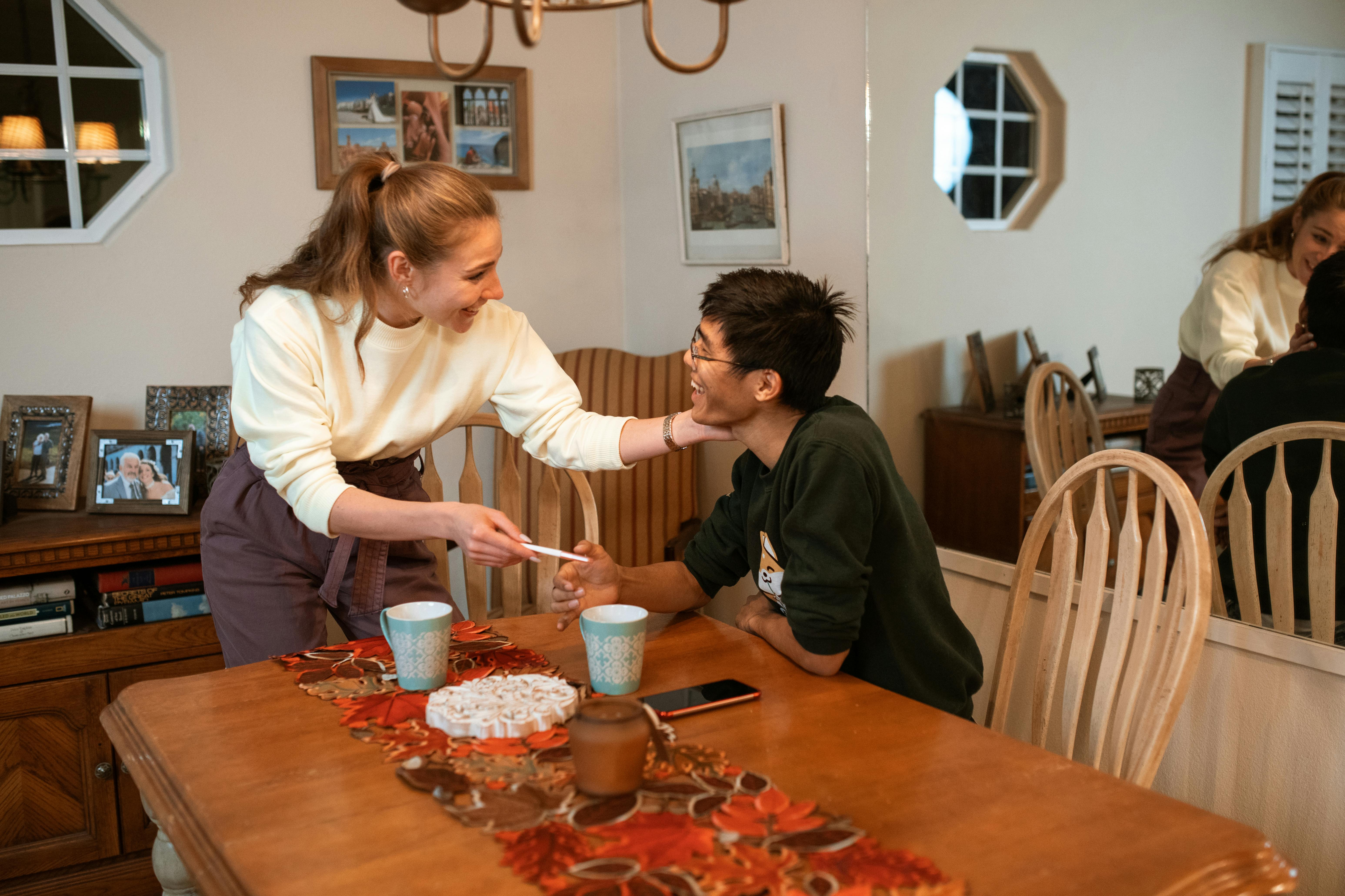 Happy couple shares exciting pregnancy news in a cozy dining room setting.