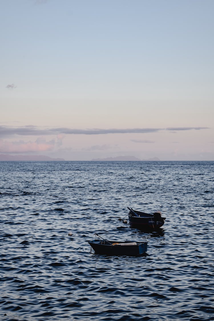 Wooden Boats Anchored On Sea