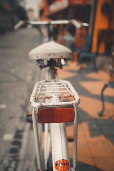Close-up view of a bike reflector, emphasizing urban transportation.
