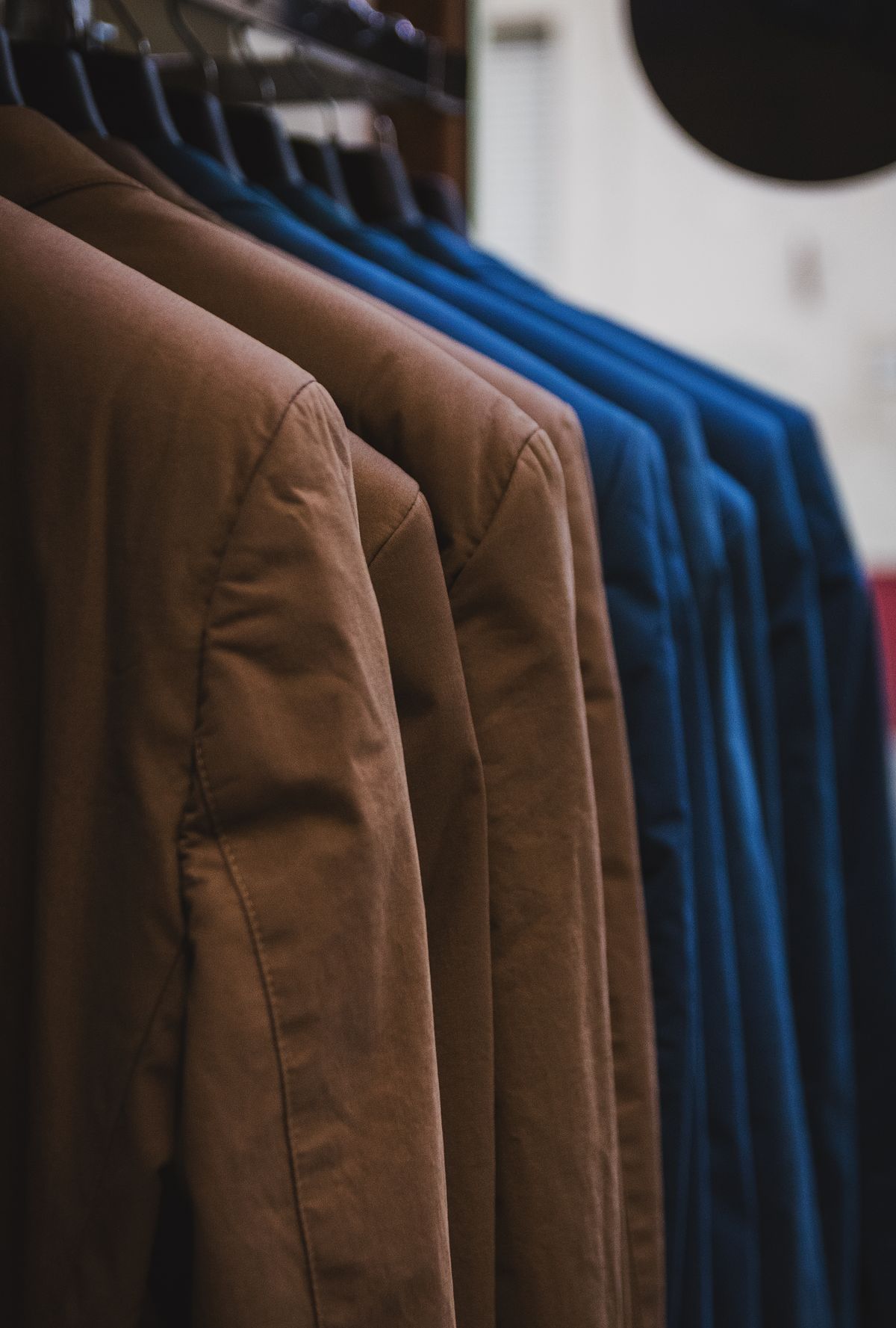 Men's jackets hanging on a rail