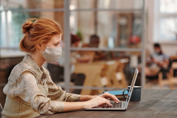 A Woman Using A In Printed Shirt Using A Laptop