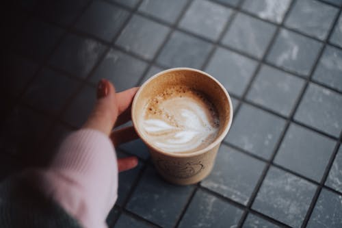 A Person Holding a Cup of Coffee