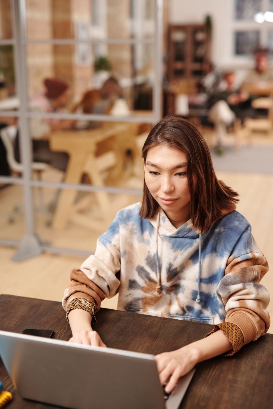 A writer drafting on a laptop in a shared coworking space — photo by Diva Plavalaguna on Pexels