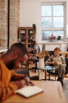 Group of people collaborating and studying in a cozy, modern workspace