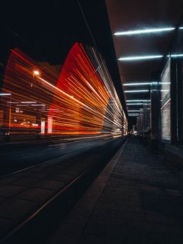 Vivid long exposure of city lights on a busy street at night, capturing motion and energy.