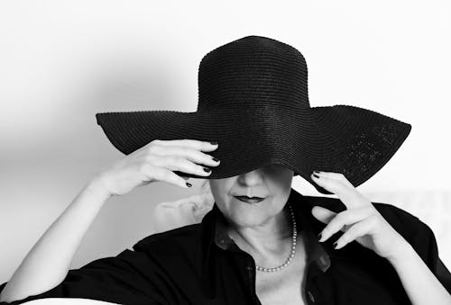 Black and White Portrait of Woman in a Large Black Hat